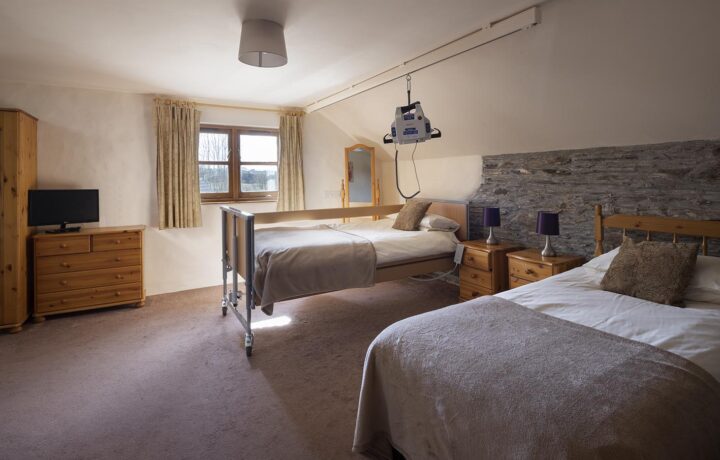 Valley View accessible bedroom with ceiling hoist, electric profiling bed at Treworgans Farm Holidays wheelchair accessible holiday cottages.