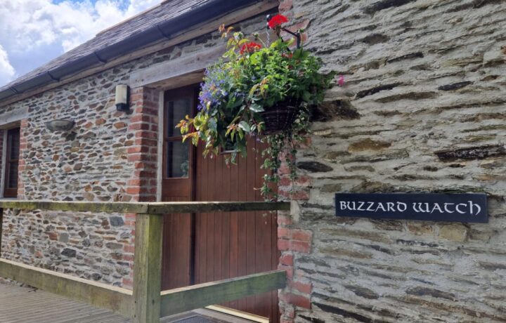Buzzard Watch front door showing slate nameplate and ramped access.