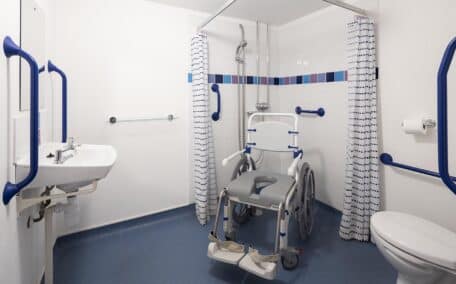 The ensuite wetroomin this case equiped with a self propelled shower chair features a wheel in shower and sink with clear underspace